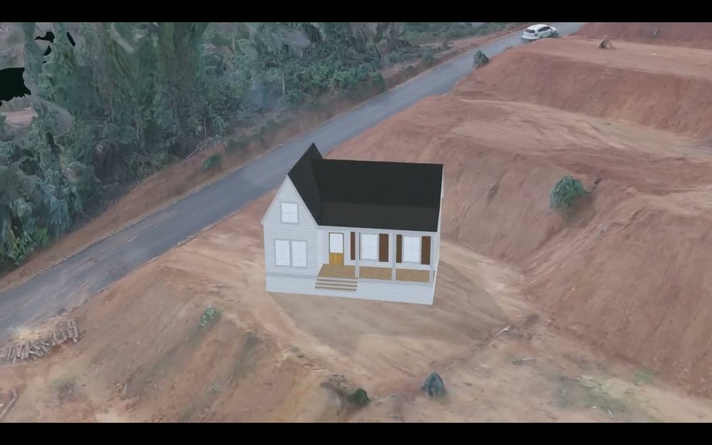 Una vivienda modular colocada sobre el lote real, junto al camino interior del loteo